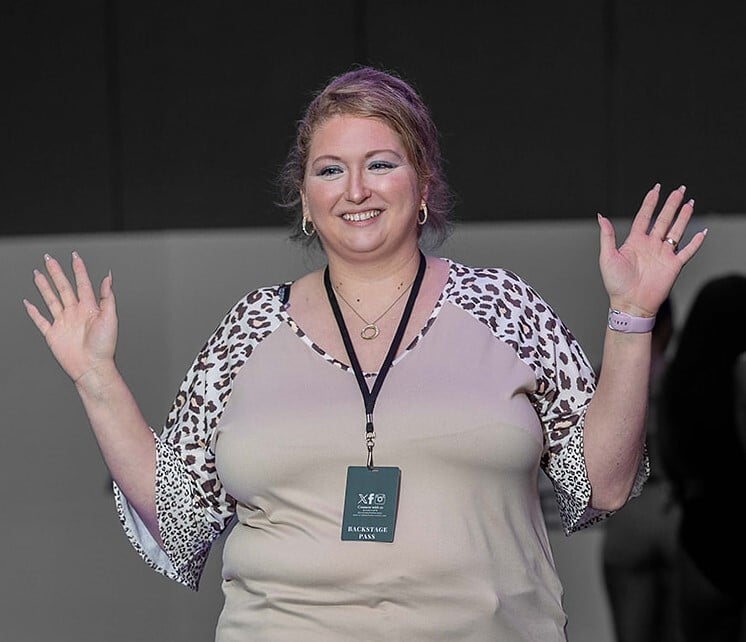 Amanda Henson, Founder and Designer of Busty & Beyond, on runway at fashion show